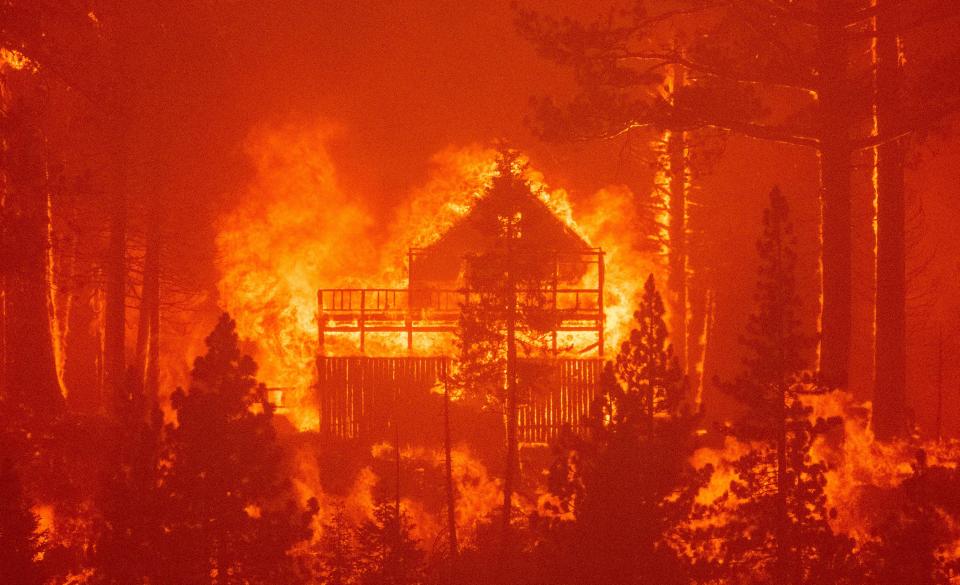 Flames consume multiple homes as the Caldor Fire pushes into South Lake Tahoe, California on August 30, 2021. / Credit: Josh Edelson/AFP via Getty Images