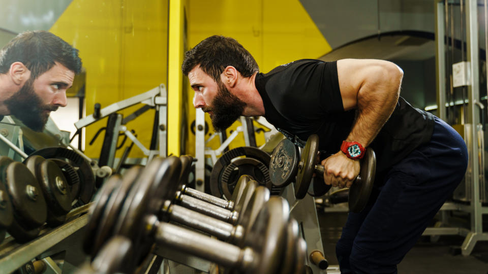 A man performing a dumbbell bent-over row