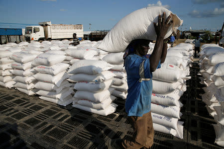 A man carries sacks of food aid for distribution to Internally displaced people (IDPs) in the POC (Protection of Civilians) Camp, run by the UN Mission in South Sudan near the town of Malakal, in the Upper Nile state of South Sudan, September 9, 2018. REUTERS/Baz Ratner