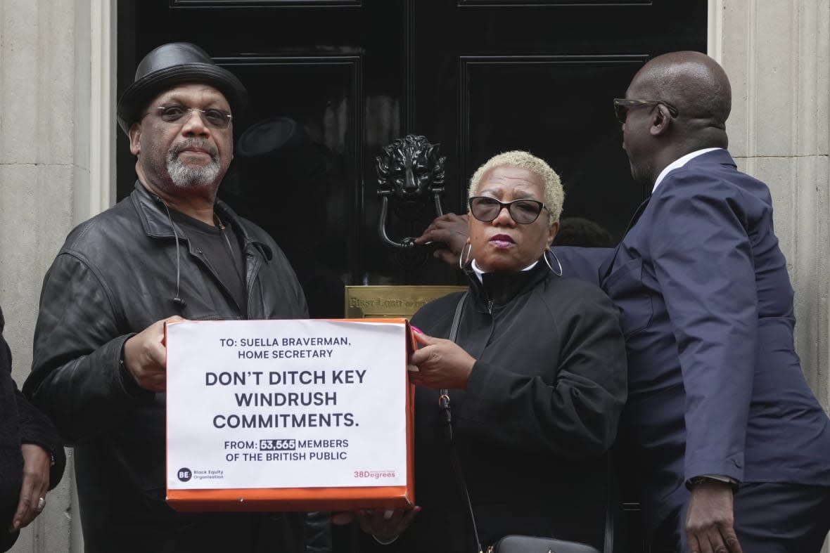 From left, Windrush campaigners, Auckland Elwaldo Romeo, Glenda Caesar and Patrick Vernon hand in a letter to Downing Street, Thursday April, 6, 2023. (AP Photo/Kin Cheung)