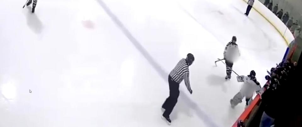 A clip of the player attacking an opposing coach with their hockey stick.