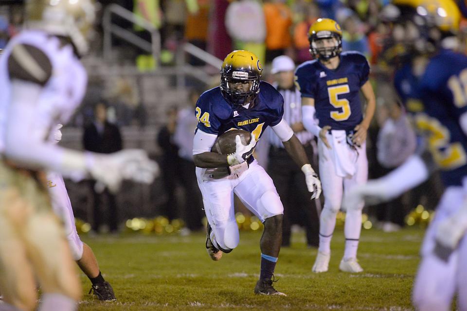 Grand Ledge's Ba Blamo carries the ball against Holt during a game in late October of 2014.