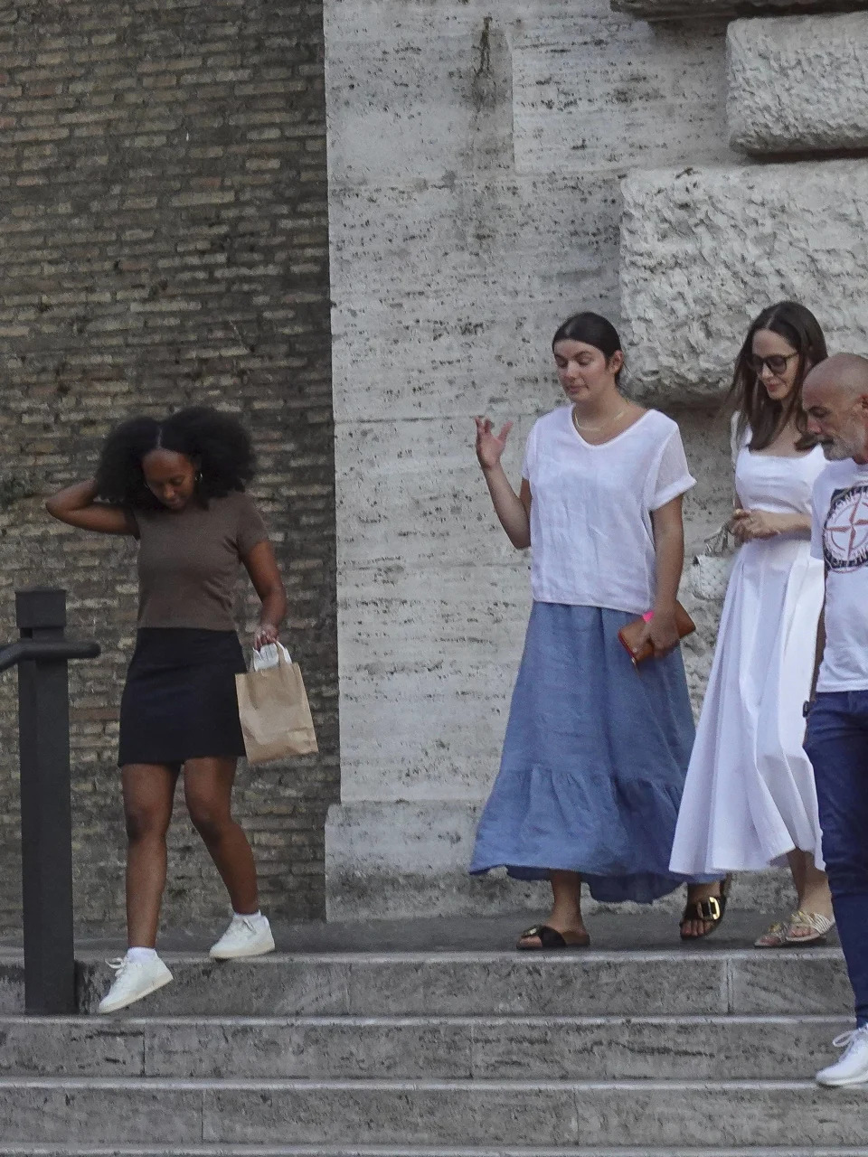 Zahara was seen walking out of the Vatican Museums in Italy with Angie in July 2022, wearing a stylish yet chill ensemble that included a black skirt, a brown tee and white sneakers.