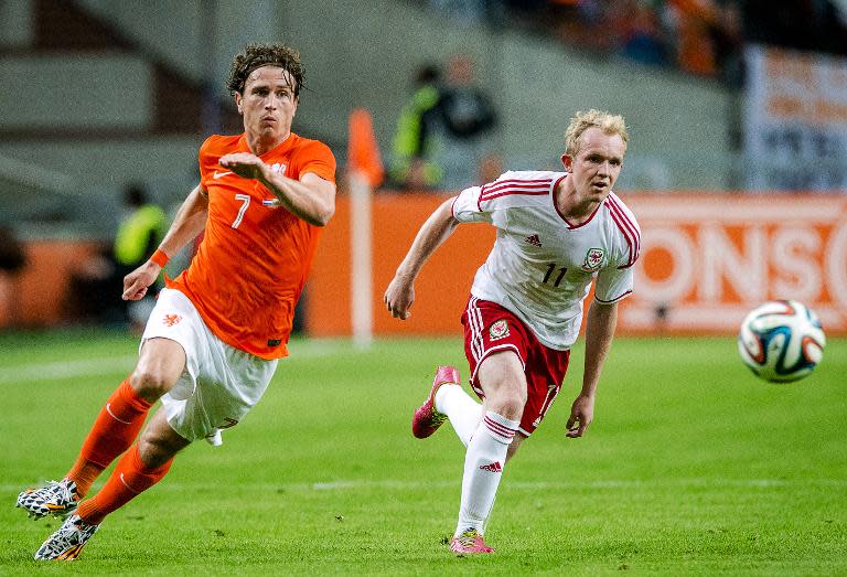 Netherland's Daryl Janmaat (L) and Wales' Jonathan Williams run for the ball during the friendly football match between the Netherlands and Wales on June 4, 2014 in Amsterdam