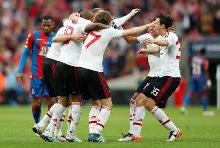 Britain Football Soccer - Crystal Palace v Manchester United - FA Cup Final - Wembley Stadium - 21/5/16 Manchester United players celebrate winning the final as Jason Puncheon looks dejected Action Images via Reuters / John Sibley