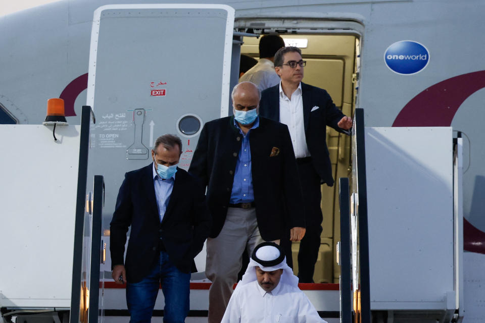 U.S. citizens Siamak Namazi, rear right, Emad Sharqi, left, and Morad Tahbaz, center, disembark from a Qatari jet upon their arrival at the Doha International Airport