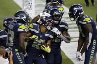 Seattle Seahawks wide receiver Freddie Swain center, celebrates with teammates, including wide receiver DK Metcalf, right, after Swain scored a touchdown against the New England Patriots during the second half of an NFL football game, Sunday, Sept. 20, 2020, in Seattle. (AP Photo/Elaine Thompson)