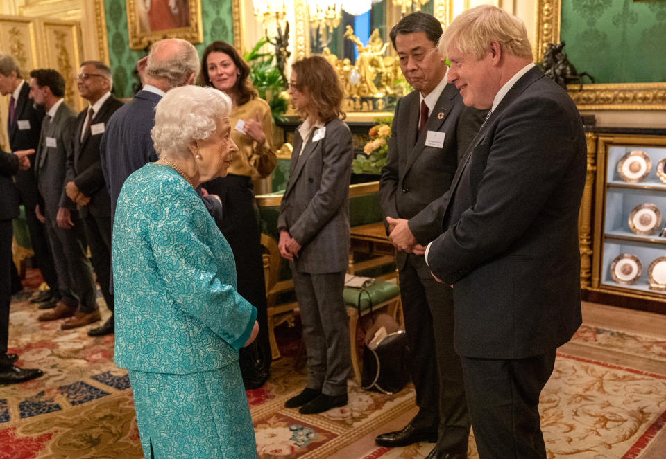 WINDSOR, UNITED KINGDOM - OCTOBER 19:  Britain's Queen Elizabeth II (L) greets British Prime Minister, Boris Johnson (R) during a reception for international business and investment leaders at Windsor Castle to mark the Global Investment Summit on October 19, 2021 in Windsor, England.  (Photo by Arthur Edwards-Pool/Getty Images)