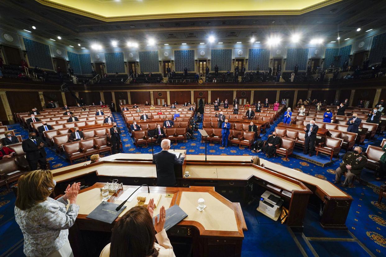 President Joe Biden addresses a joint session of Congress, Wednesday, April 28, 2021, in the House Chamber at the U.S. Capitol in Washington, as Vice President Kamala Harris and House Speaker Nancy Pelosi of Calif., stand and applaud.