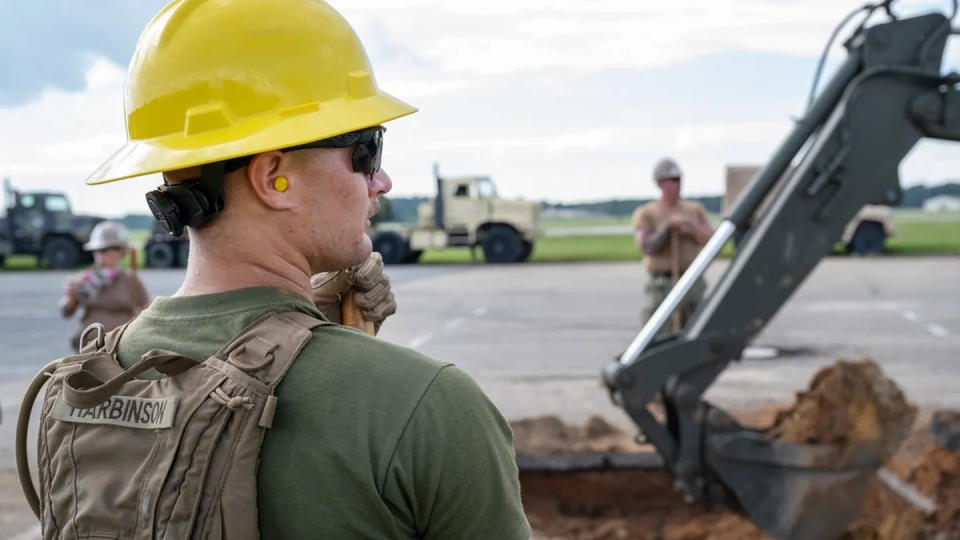A Marine prepares to help Navy sailors dig out debris from a simulated crater in support of Large Scale Exercise 2023 at Seymour Johnson Air Force Base, N.C., Aug. 10. (Tech. Sgt. Christopher Hubenthal/Air Force)