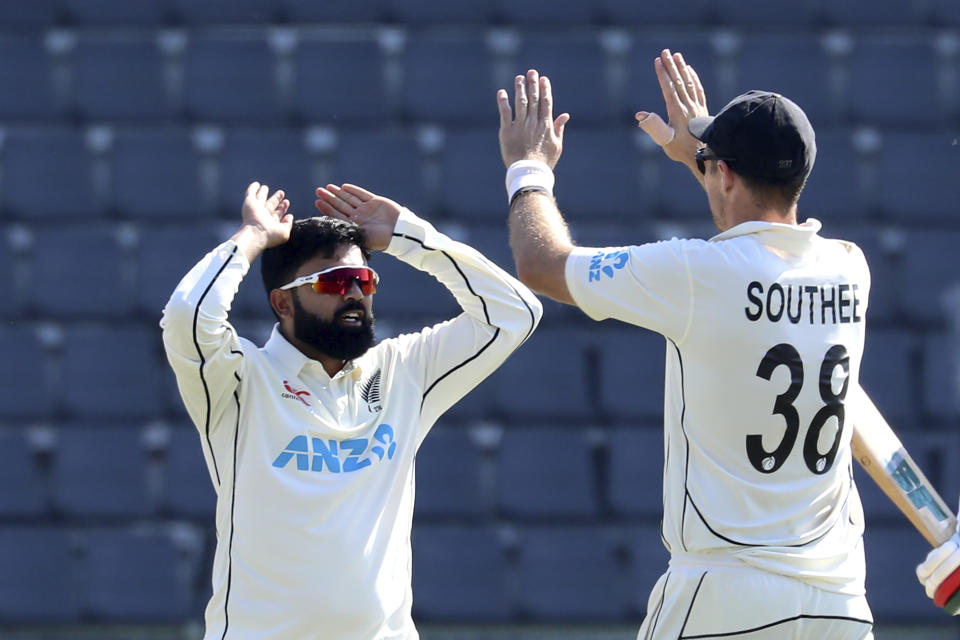 New Zealand's cricketer Ajaz Patel celebrates with Tim Southee after dismissing Bangladeshi batsman Mushfiqur Rahim during the fourth day of the first test cricket match at Sylhet, Bangladesh, Friday, Dec. 1, 2023. (AP Photo/Mosaraf Hossain)
