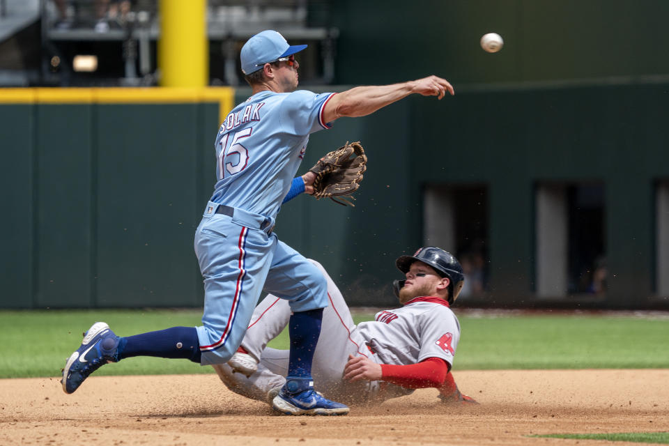 Texas Rangers second baseman Nick Solak (15) forces out Boston Red Sox's Alex Verdugo as he turns a double play during the fifth inning of a baseball game Sunday, May 2, 2021, in Arlington, Texas. (AP Photo/Jeffrey McWhorter)