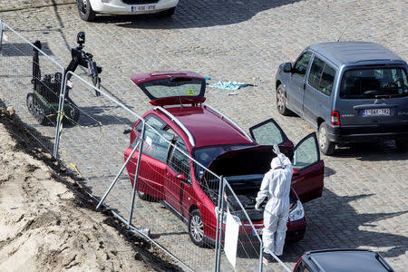 A forensics expert stands next to a car which had entered the main pedestrian shopping street in the city at high speed, in Antwerp, Belgium, March 23, 2017. REUTERS/Joris Herregods