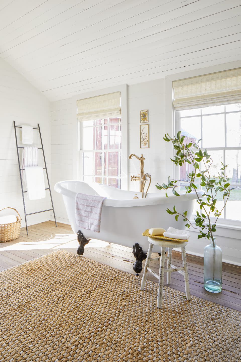 white farmhouse bathroom with clawfoot bathtub