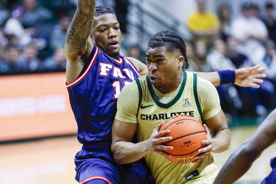 Charlotte guard Isaiah Folkes, right, drives against Florida Atlantic guard Alijah Martin, left, during the second half of an NCAA college basketball game in Charlotte, N.C., Saturday, Jan. 6, 2024. (AP Photo/Nell Redmond)