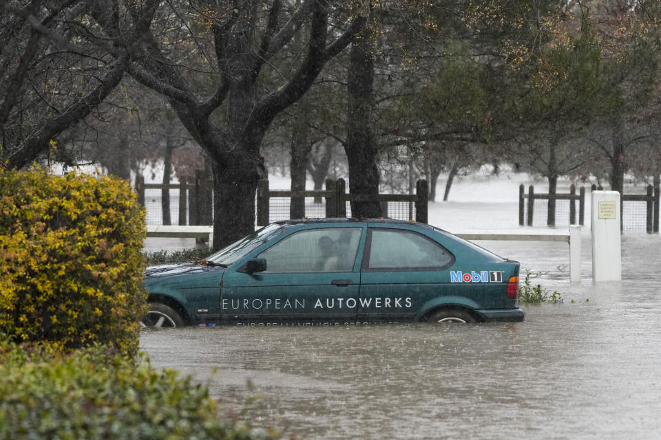 A car lies semi submerged in flood waters at Camden on the outskirts of Sydney, Australia, Monday, July 4, 2022. More than 30,000 residents of Sydney and its surrounds have been told to evacuate or prepare to abandon their homes on Monday as Australia’s largest city braces for what could be its worst flooding in 18 months. (AP Photo/Mark Baker)