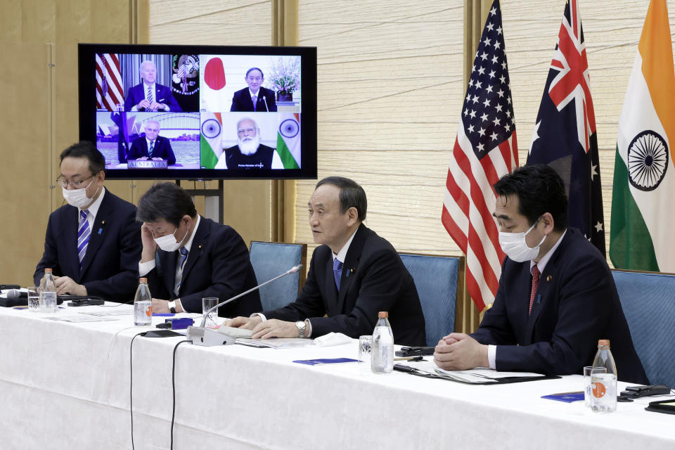 Japan's Prime Minister Yoshihide Suga, second right, speaks during the virtual summit of the leaders of Australia, India, Japan and the U.S., a group known as “the Quad", at his official residence in Tokyo, Japan, on Friday, March 12, 2021. On a monitor displays U.S. President Joe Biden, top right, Scott Morrison, Australia's Prime Minister, bottom left, and Narendra Modi, India's Prime Minister, bottom right. (Kiyoshi Ota/Pool via AP)