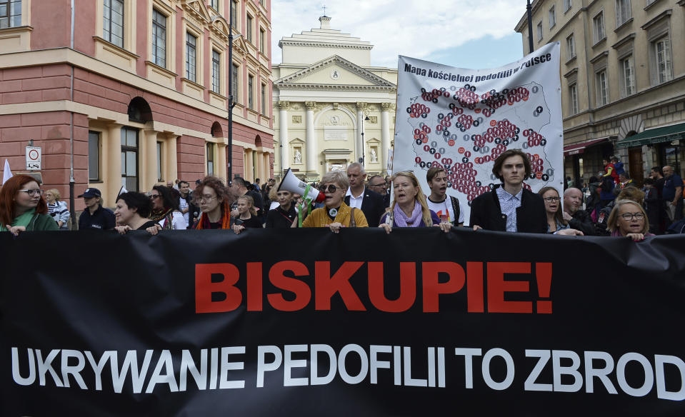 Protesters carry a map of Poland with 255 documented cases of sexual abuse of minors by the country's Catholic priests, as they march in Warsaw, Poland, Sunday, Oct. 7, 2018, demanding the church to stop protecting pedophile priests. The writing on the banner reads: "Bishop. Hiding Pedophilia is a Crime." (AP Photo/Alik Keplicz)