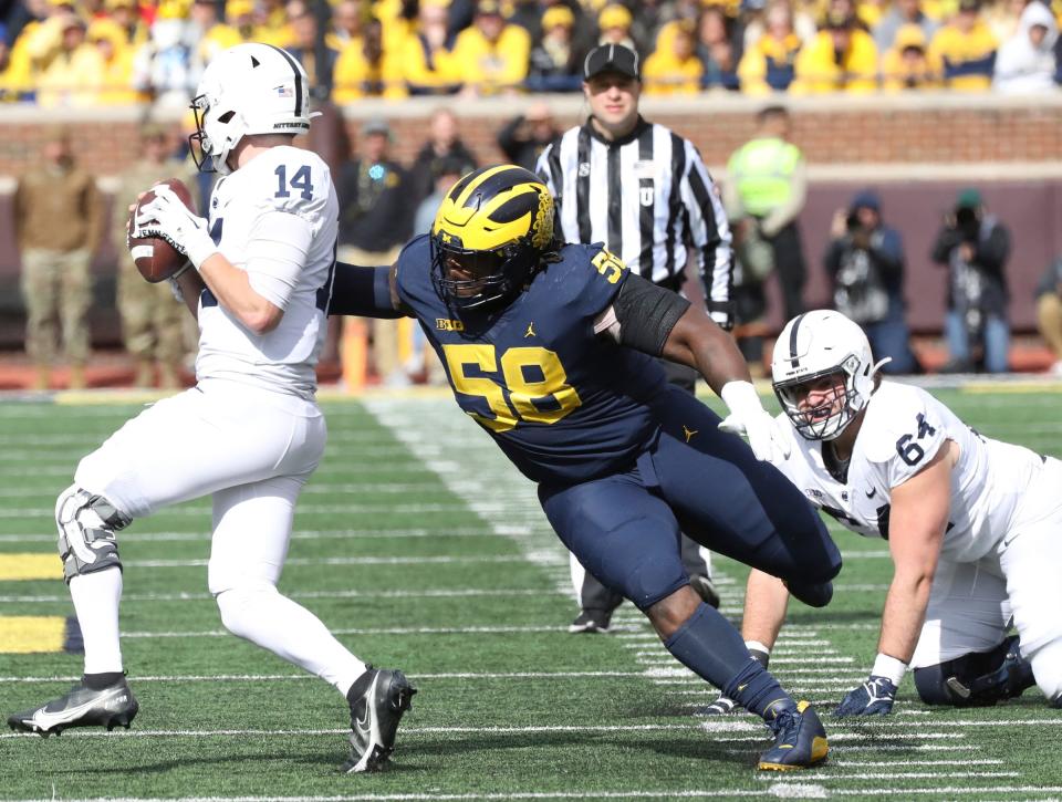 Michigan defensive lineman Mazi Smith (58) pressures Penn State quarterback Sean Clifford (14) during the second half Oct. 15, 2022 at Michigan Stadium in Ann Arbor.