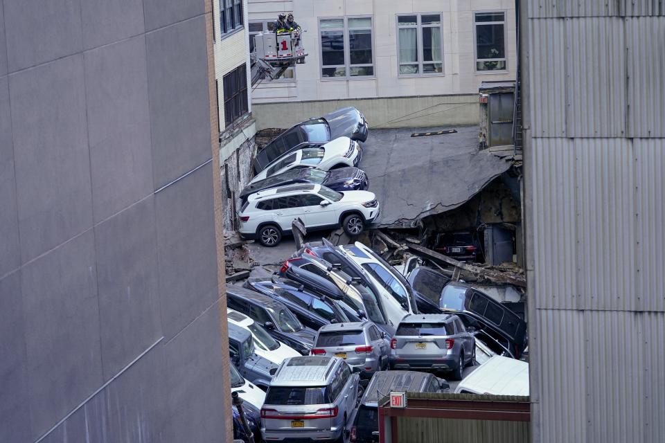 Firefighters work at the scene of a partial collapse of a parking garage in the Financial District of New York, Tuesday, April 18, 2023, in New York. (AP Photo/Mary Altaffer)