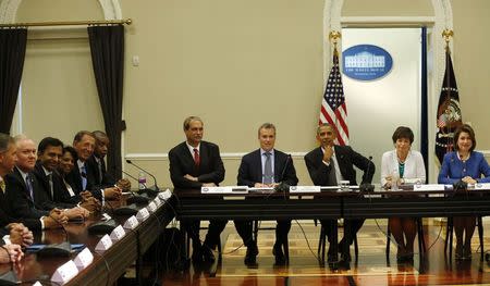U.S. President Barack Obama and his advisors hold a meeting with company executives and their small business suppliers to discuss ways to strengthen the economy at the White House in Washington July 11, 2014. REUTERS/Kevin Lamarque