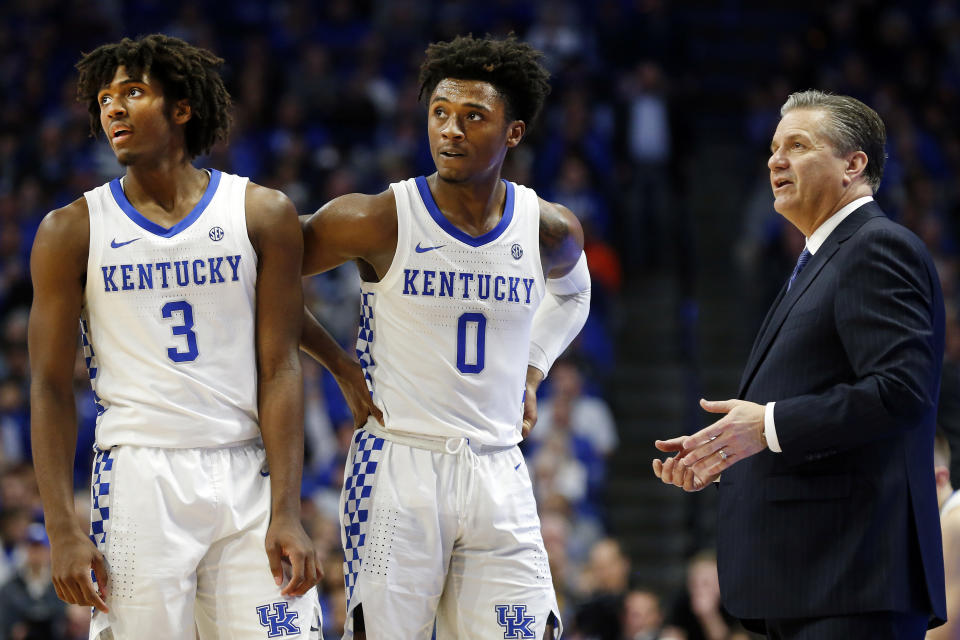 Kentucky's Tyrese Maxey (3), and Ashton Hagans (0), listen as head coach John Calipari instructs them during the second half of an NCAA college basketball game in Lexington, Ky., Saturday, Jan 4, 2020. Kentucky won 71-59. (AP Photo/James Crisp)