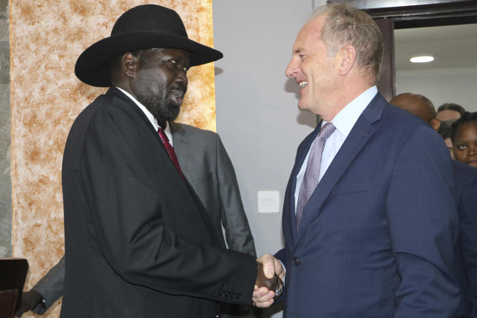 South Sudan's President Salva Kiir, left, shakes hands with U.N. chief, David Shearer, right, during meetings with the U.N. Security Council on Sunday, Oct. 20, 2019, about the status of the country's peace deal. Machar made an impassioned plea to a visiting United Nations Security Council delegation that met with him and President Salva Kiir to urge speedier progress in pulling the country out of a five-year civil war. (AP Photo/Sam Mednick)