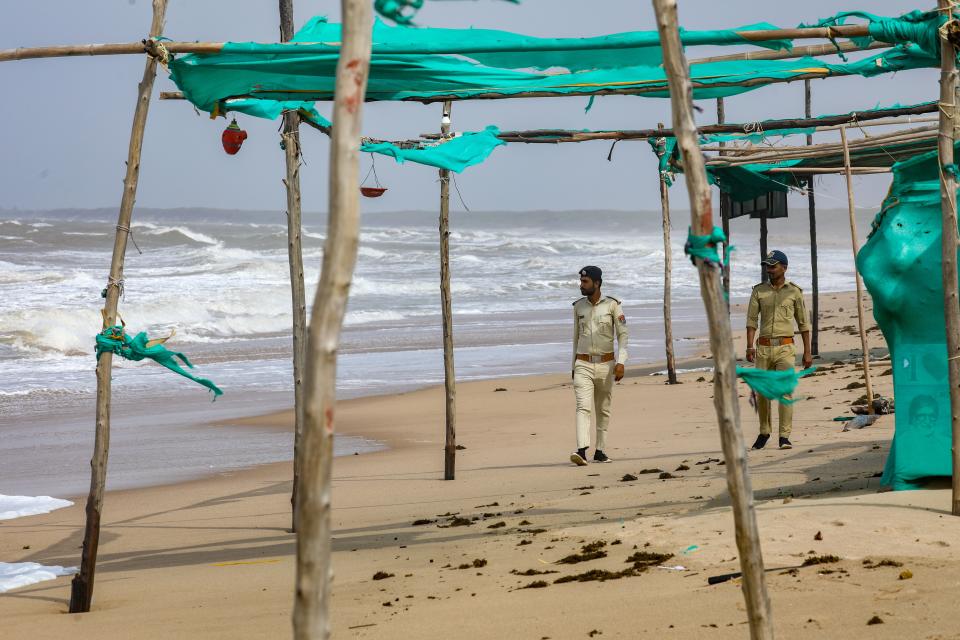 Police officers patrol the coast during high tide in Mandvi, in the Kutch district of the western state of Gujarat, India (EPA)