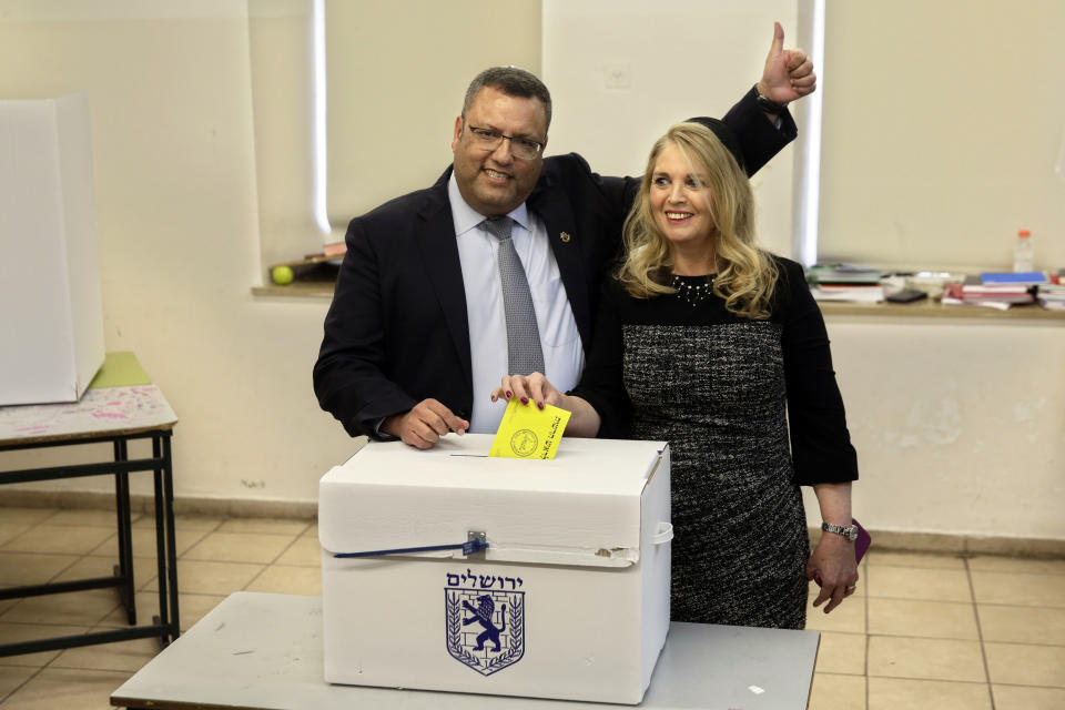 Mayoral candidate Moshe Lion, left, and his wife pose for the media as they cast their votes at a polling station in Jerusalem, Tuesday, Nov. 13, 2018. Israelis were choosing their next mayors in dozens of locations across the country Tuesday, with the main focus on the largest city of Jerusalem. (AP Photo/Mahmoud Illean)