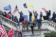 FILE - Insurrectionists loyal to President Donald Trump stand on stairs to a balcony on the West Front of the U.S. Capitol on Jan. 6, 2021, in Washington. (AP Photo/Jose Luis Magana, File)