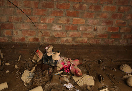 A Minnie Mouse soft toy lies in mud after rivers breached their banks due to torrential rains, causing flooding and widespread destruction in Carapongo Huachipa, Lima, Peru, March 24, 2017. REUTERS/Mariana Bazo