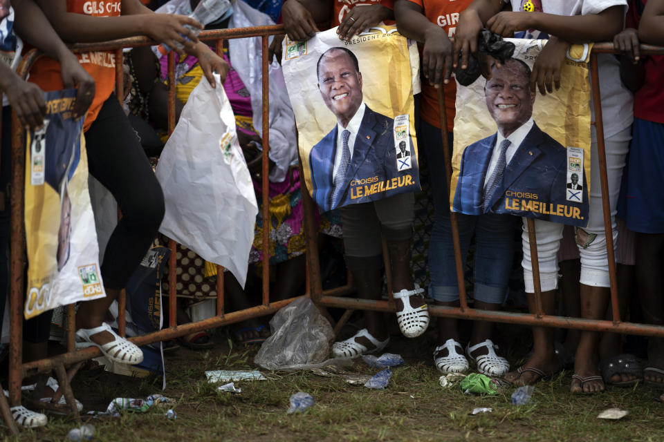 Supporters wait for the arrival of the Ivory Coast President Alassane Ouattara at a rally in Anyama, in the outskirts of Abidjan, Ivory Coast, Wednesday, Oct. 28, 2020. Ouattara, who first came to power after the 2010 disputed election whose aftermath left more than 3,000 people dead, is now seeking a third term in office. The candidate maintains that he can serve a third term because of changes to the country's constitution, though his opponents consider his candidacy illegal. (AP Photo/Leo Correa)