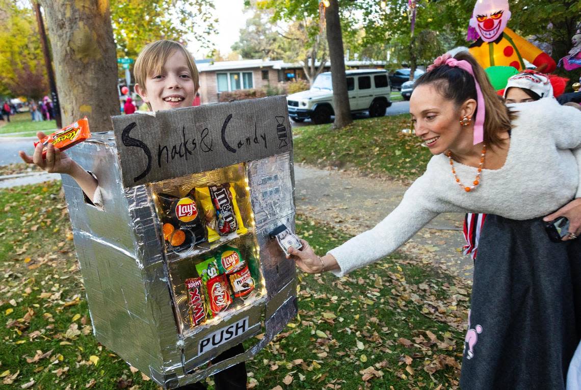 Rowan Anderson, 9, wears a homemade vending machine costume for trick-or-treating on Harrison Boulevard in Boise during Halloween on Oct 31, 2022.