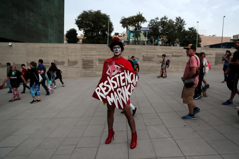 Demonstrators take part in a protest marking the National Day Against Femicide in Santiago