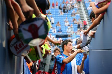 Sep 1, 2016; New York, NY, USA; Kei Nishikori of Japan signs autographs after defeating Karen Khachanov of Russia (not pictured) on day four of the 2016 U.S. Open tennis tournament at USTA Billie Jean King National Tennis Center.Anthony Gruppuso-USA TODAY Sports