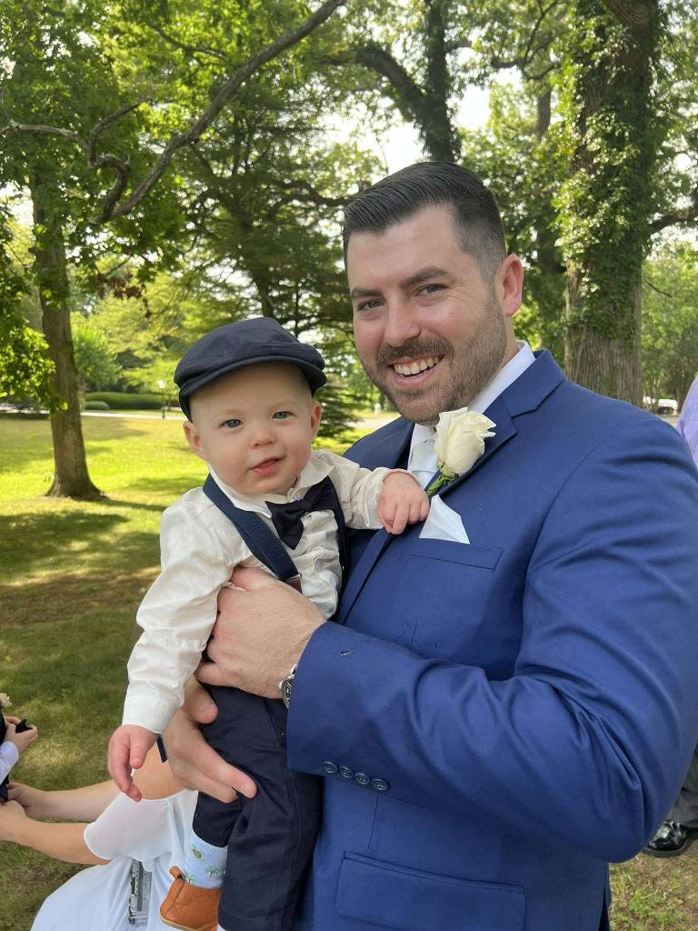 Diller smiles with his infant son at his sister’s wedding. Facebook/Jean O'Donnell