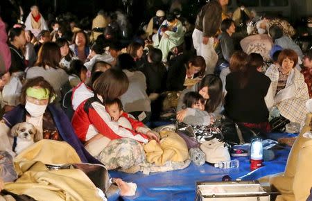 Evacuees gather in front of the town office building after an earthquake in Mashiki town, Kumamoto prefecture, southern Japan, in this photo taken by Kyodo April 15, 2016. Mandatory credit REUTERS/Kyodo