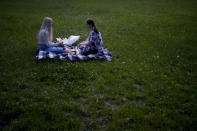 Women sit for a picnic at Natalka Park in Kyiv, Ukraine, Tuesday, June 7, 2022. (AP Photo/Natacha Pisarenko)