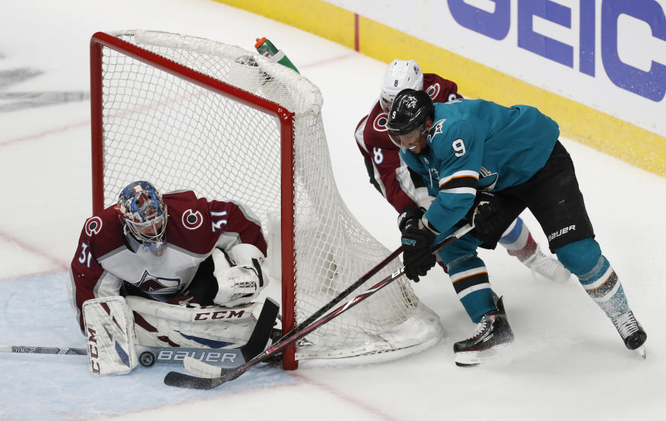 Colorado Avalanche goaltender Philipp Grubauer (31) makes a save against the San Jose Sharks' Evander Kane (9) in the third period of Game 1 of an NHL hockey second-round playoff series at the SAP Center in San Jose, Calif., on Friday, April 26, 2019. (AP Photo/Josie Lepe)