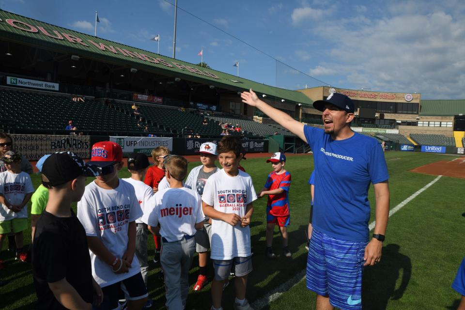 Chris Hagstrom-Jones coaches children at baseball camp at Four Winds Field on Friday July 7, 2023.