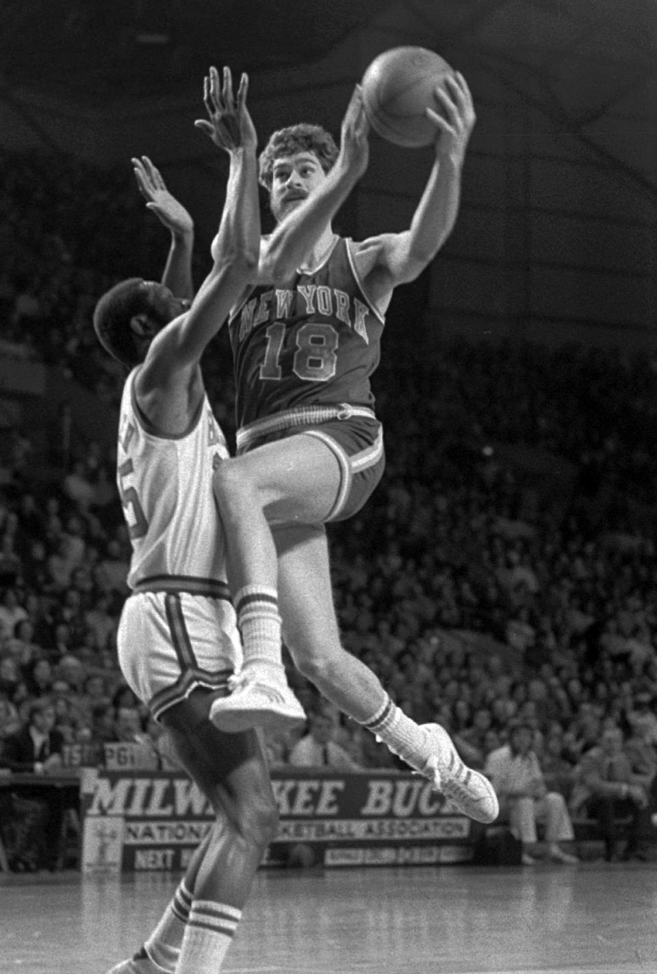 FILE - In this Dec. 29, 1974 file photo, New York Knicks' Phil Jackson (18) goes to the basket against Milwaukee Bucks' Cornell Warner during an NBA basketball game in Milwaukee. Carmelo Anthony says he has heard that 11-time NBA champion coach Phil Jackson will be "coming on board" in a leadership capacity with the New York Knicks, though cautioned that nothing is yet official. Anthony made the comments Wednesday, March 12, 2014, to reporters in Boston, where the Knicks are playing the Celtics. (AP Photo/File)