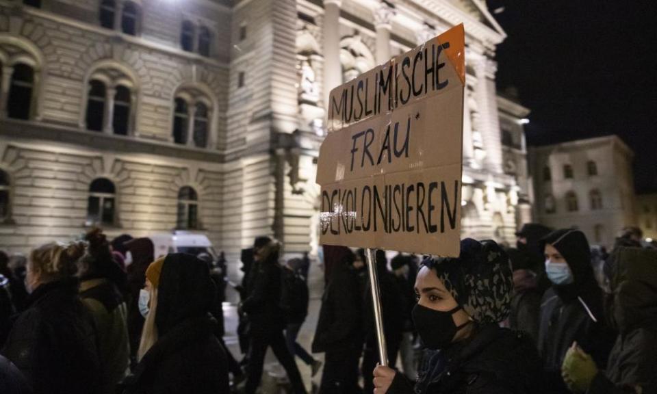 Demonstrators carry placards in a protest after the burqa ban referendum was narrowly accepted by the electorate, in Zurich, Switzerland, 7 March 2021.