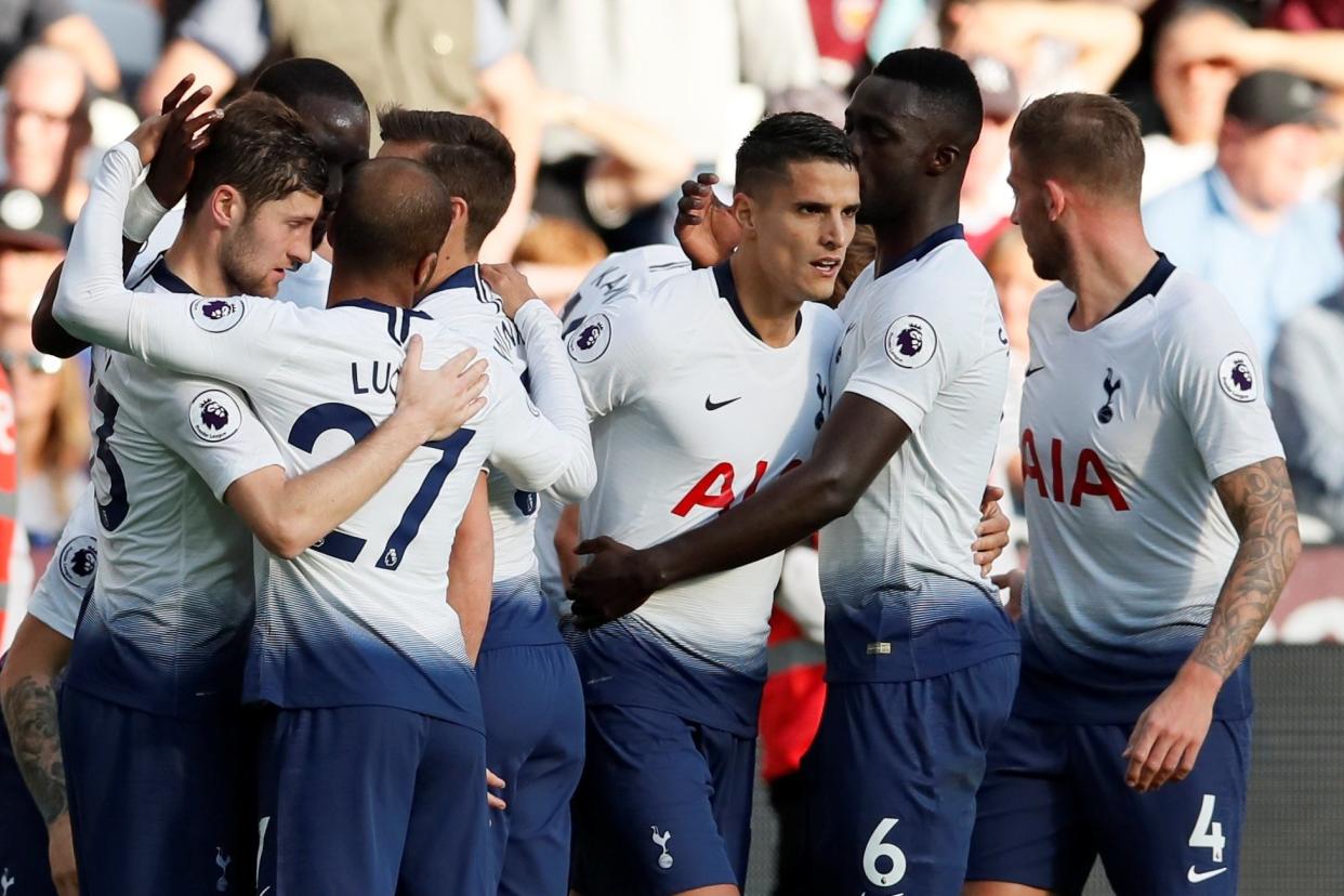 Match winner: Erik Lamela celebrates with his Tottenham team-mates at West Ham: REUTERS