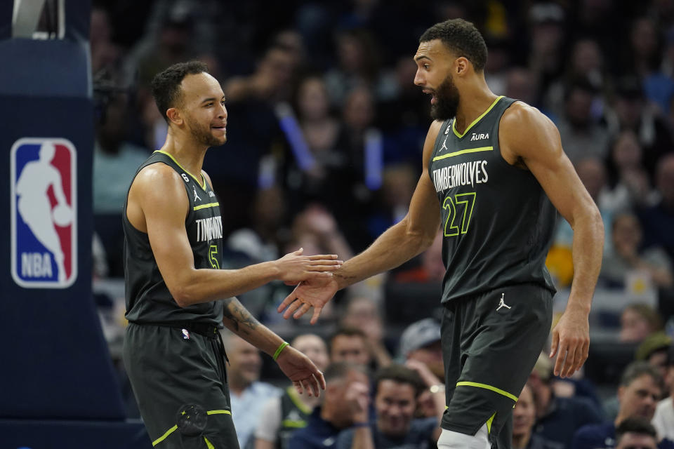 Minnesota Timberwolves forward Kyle Anderson, left, and center Rudy Gobert (27) react during the second half of the team's NBA basketball play-in tournament game against the Oklahoma City Thunder, Friday, April 14, 2023, in Minneapolis. (AP Photo/Abbie Parr)