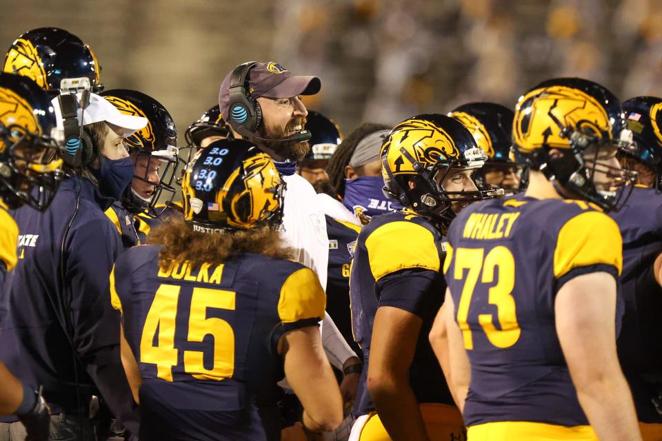 Head coach Sean Lewis and his Kent State football team face a rough September schedule, with games at Washington, Oklahoma and Georgia.