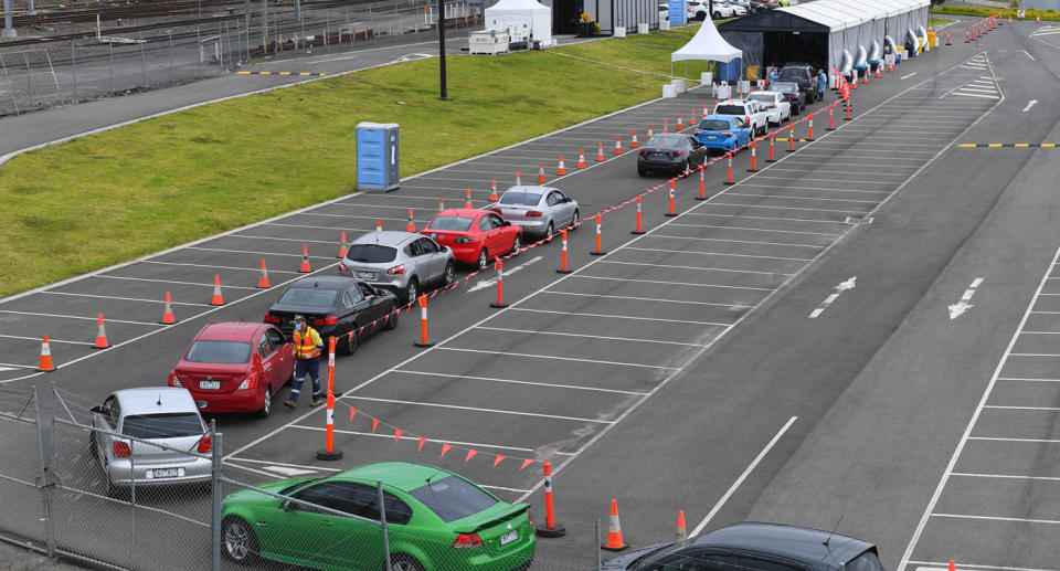 Cars wait in a line at a drive through Covid-19 testing facility in Dandenong, Melbourne. Source: AAP  