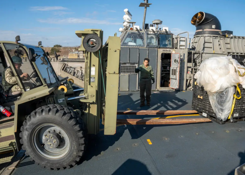 U.S. Navy personnel prepare to move portions of a Chinese surveillance balloon that were recovered off the coast of South Carolina after being shot down on February 4, 2023 and then carried ashore by a Landing Craft Air Cushion (LCAC) hovercraft. <em>U.S. Navy</em>