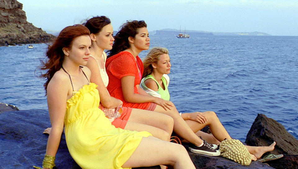 The friends sitting on rocks by the sea in a scene from "The Sisterhood of the Traveling Pants"