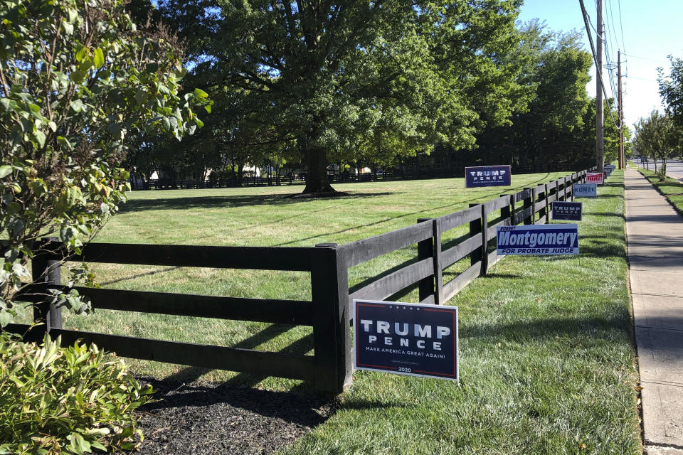 Signs in support of President Donald Trump and other Republican candidates on a lawn of a suburban Dublin, Ohio, home on Friday, Sept. 18, 2020. (AP Photo/Julie Carr Smyth)