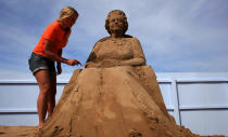 WESTON-SUPER-MARE, ENGLAND - MAY 28: Sand sculpture artist Nicola Wood completes a sand sculpture she has created of Queen Elizabeth II at the annual Weston-super-Mare Sand Sculpture festival on May 28, 2012 in Weston-Super-Mare, England. Now in its seventh year, the festival, which opens to the public on Friday, features sand sculptures from award-winning artists from across the globe. Using 4000 tonnes of Weston beach sand this year's giant sand art display, created by 15 international artists on the theme Fun and Games, runs throughout the summer until September 9. (Photo by Matt Cardy/Getty Images)